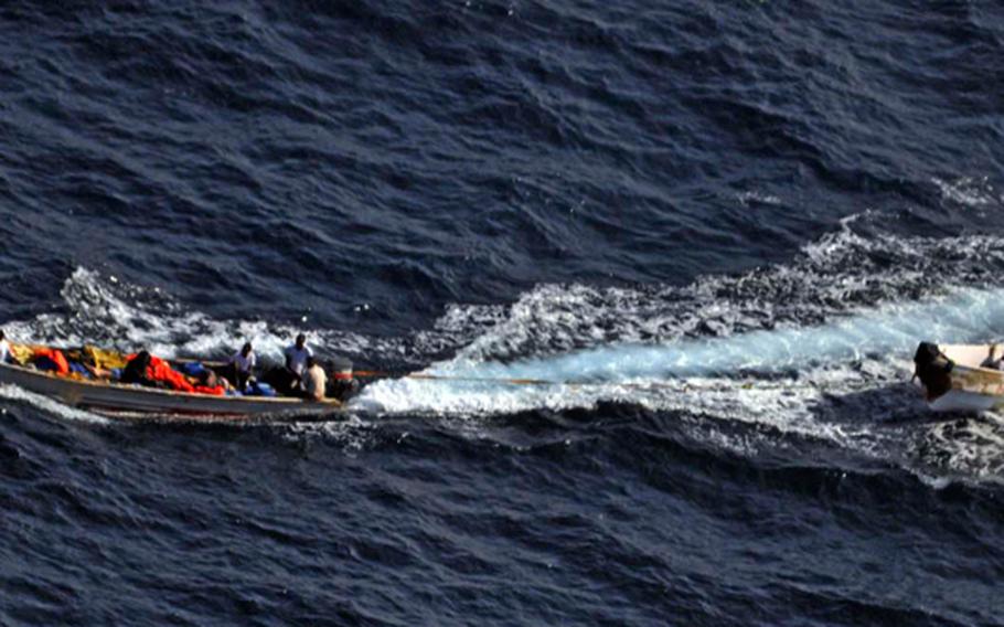 Naval forces photograph two suspicious skiffs together before they split up in an attempt to escape Feb. 19, 2013, about 230 miles for the Somali Coast. European Union Naval Force Somalia - Operation Atalanta seized the two skiffs and detained nine suspected pirates.