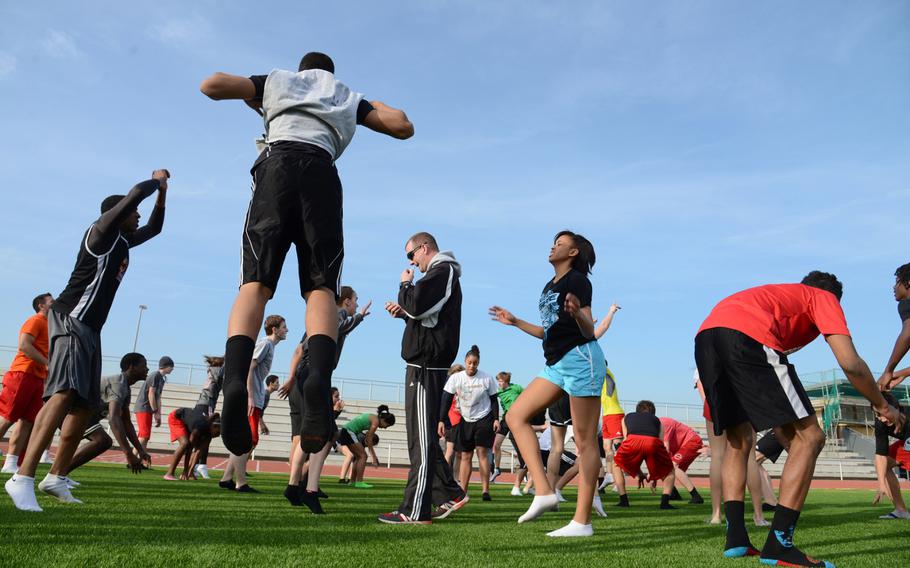 Kaiserslautern track and field coach Dennis DePriest watches the stopwatch as his team exercises at they get ready for the 2013 DODDS-Europe spring sports season. 

