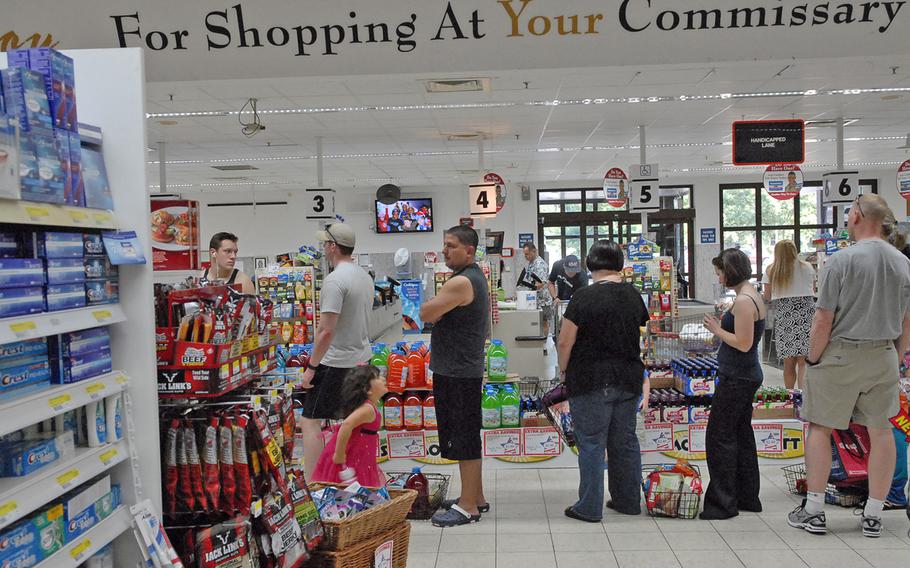 Shoppers set down their baskets of groceries while waiting to check out Monday evening at the Vogelweh Commissary. With the nearby Ramstein Commissary closed and staffing reduced at the Vogelweh store due to the first day of the Defense Department's civilian furlough, Vogelweh customers faced unusually long lines. 