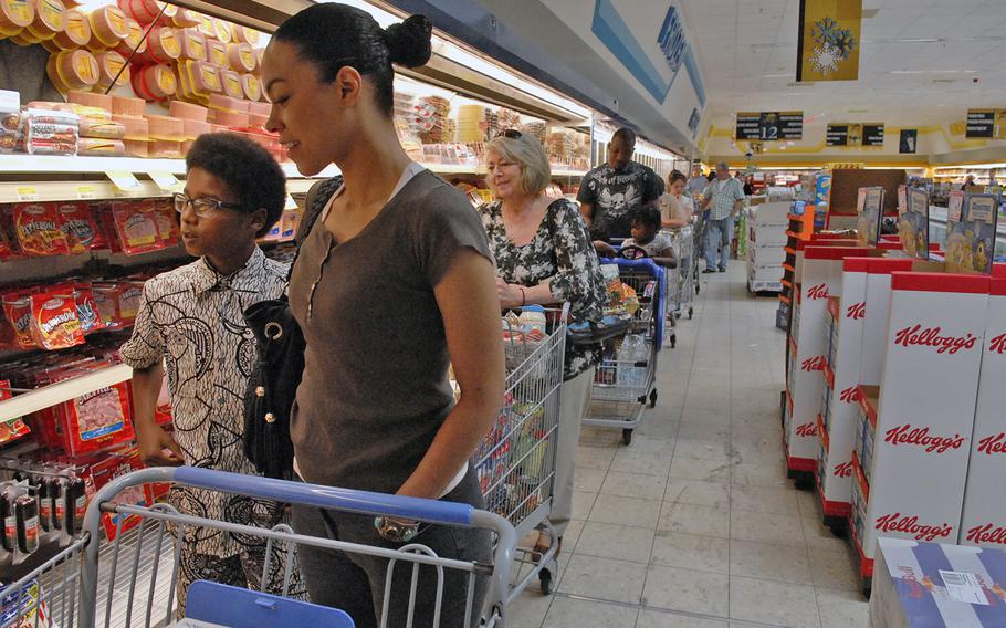 Air Force spouse Kristina Gadiaga was about midway through a line that extended the length of the store and beyond Monday evening at the Vogelweh Commissary. With the nearby Ramstein Commissary closed and staffing reduced at the Vogelweh store due to the first day of the Defense Department's civilian furlough, Vogelweh customers faced unusually long lines. 