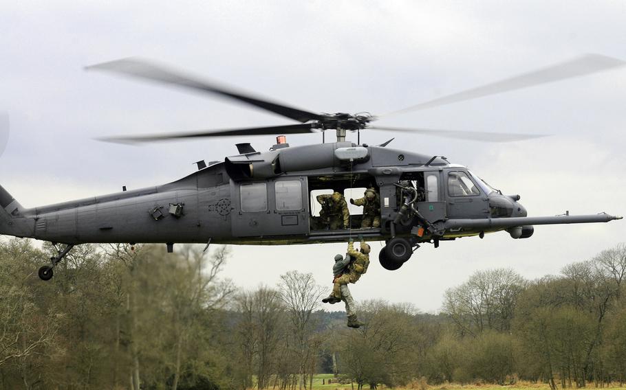 U.S. airmen are hoisted onto an HH-60G Pave Hawk during a training exercise in the Stanta Training Area, England, on March 20, 2013.  