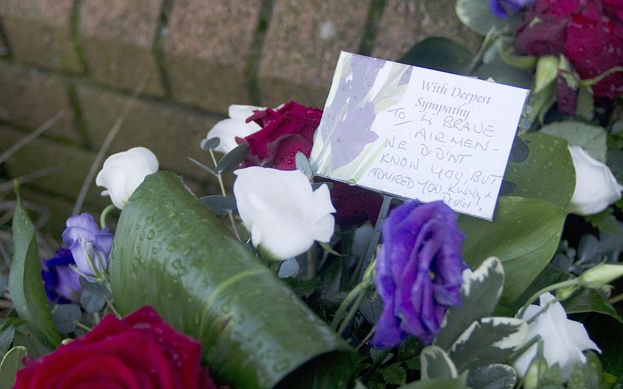 Flowers lie near one of RAF Lakenheath's gates on Thursday, Jan. 9, 2014, in remembrance of the four airmen killed in a an HH-60G Pave Hawk helicopter crash near Salthouse, England. Investigators are still looking into the cause of the crash.

