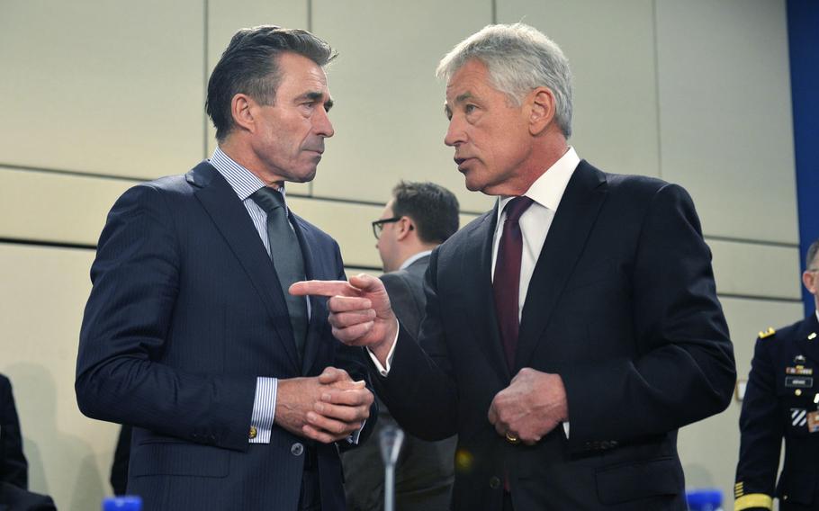 Secretary of Defense Chuck Hagel chats with NATO Secretary General Anders Fogh Rasmussen before a meeting of the NATO Ukraine Commission while attending the final day of the NATO Defense Ministerial meetings in Brussels, Belgium, Feb. 27, 2014.