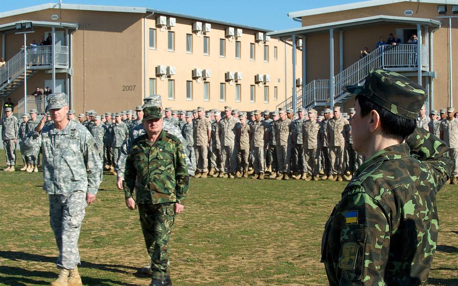 Maj. Gen. Richard C. Longo, left, deputy commander of U.S. Army Europe, and Brig. Gen. Krasimir Kanev, deputy commander of the Bulgarian Land Forces, review troops, including those from Ukraine, during the opening ceremony of exercise Saber Guardian, Friday, March 21, 2014, at the Novo Selo Training Area, Bulgaria. 