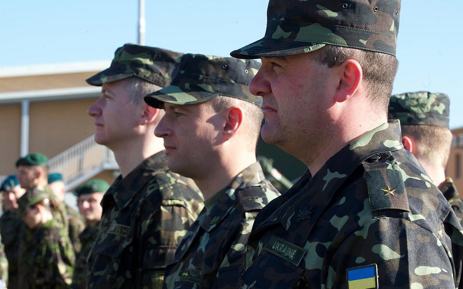 Ukrainian soldiers stand in formation at the opening ceremony for U.S. Army Europe's Saber Guardian exercise, Friday, March 21, 2014, at the Novo Selo Training Area, Bulgaria. Saber Guardian is a multinational military exercise involving about 700 military personnel from 12 nations as well as representatives from NATO.