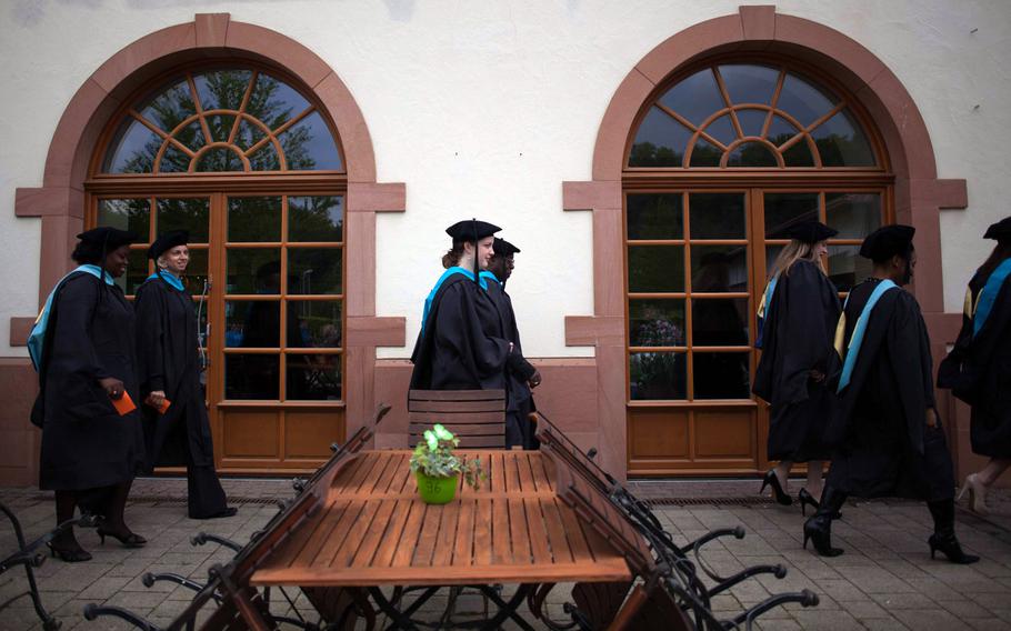 Graduates of the University of Maryland University College Europe class of 2014 walk to the commencement hall at the Gartenschau in Kaiserslautern, Germany, commencement Saturday, May 3, 2014.