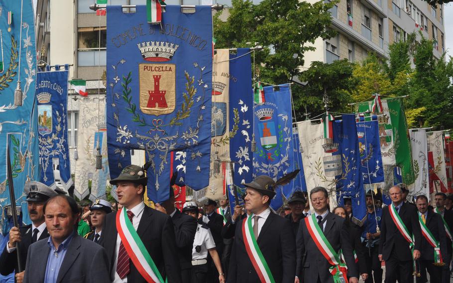 Politicians representing communities surrounding Pordenone, Italy, march in a huge parade Sunday, May 11, 2014, as thousands gathered to cheer on the country's past and present Alpini forces.