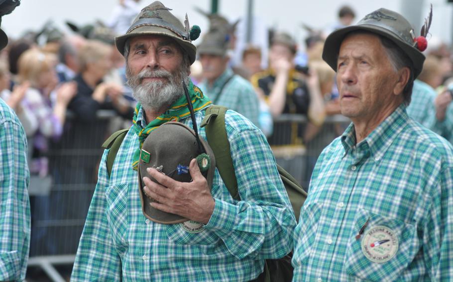 There was almost as much plaid as feathered hats on Sunday, May 11, 2014, during a parade in Pordenone, Italy, capping the 87th gathering of the Alpini. Different chapters sported different color combinations of plaid and some of those marching appeared to be doing so in remembrance of others, including this man carrying an extra hat.