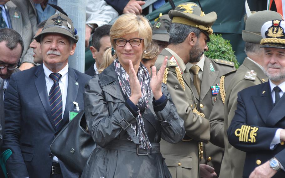 Roberta Pinotti, Italy's minister of defense, claps while Alpini forces pass by her during a parade Sunday, May 11, 2014, in Pordenone, Italy.