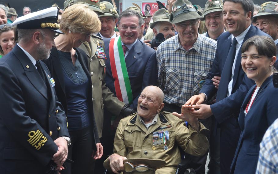 Italian Prime Minster Matteo Renzi and Minister of Defense Roberta Pinotti greet an Alpini veteran that onlookers said was the oldest surviving member of the organization in Italy. Renzi and Pinotti both flew up from Rome to attend the 87th national Alpini gathering in Pordenone, Italy, on Sunday, May 11, 2014.