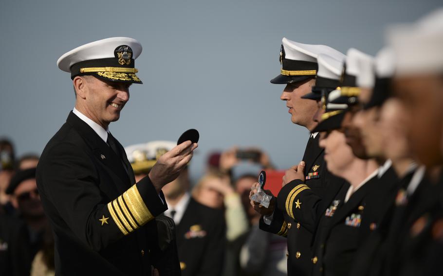 Adm. Jonathan Greenert, the Chief of Naval Operations, talks with sailors from the USS Oscar Austin at the World War II Navy memorial at Utah Beach, Normandy during the 70th anniversary D-Day commemorations, June 5, 2014.