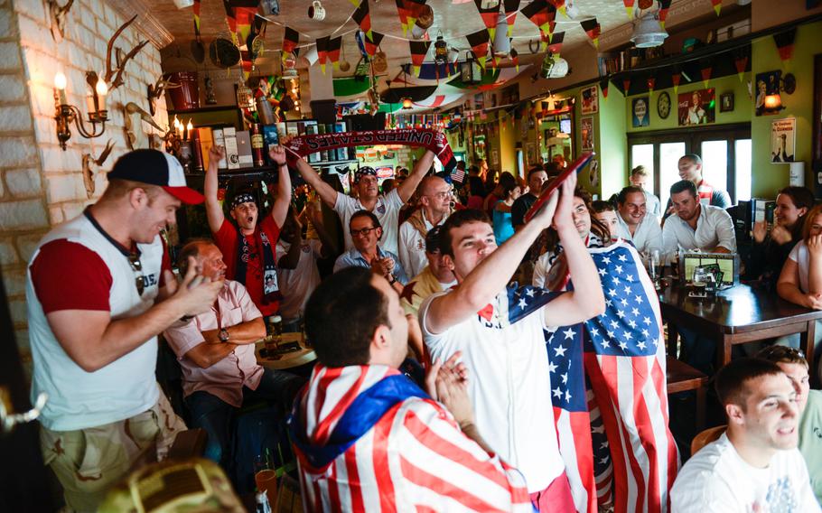 American supporters cheer after singing the national anthem in an Irish bar in downtown Kaiserslautern, Germany as the U.S. soccer team plays Germany in the World Cup, Thursday, June 26, 2014.

Joshua L. DeMotts/Stars and Stripes