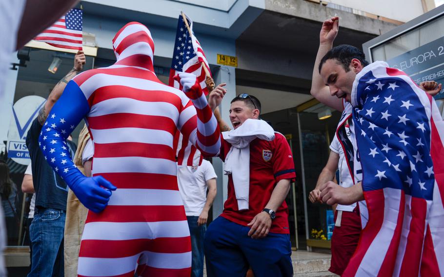 Americans cheer in support of the U.S. soccer team in downtown Kaiserslautern, Germany as the U.S. plays Germany in the World Cup, Thursday, June 26, 2014.