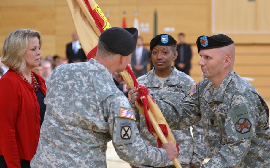 Col. David H. Carstens passes the garrison colors to Command Sgt. Maj. Roy L. Rocco, right, Wiesbaden garrison command sergeant major at a change of command ceremony Thursday, July 10, 2014 at Clay Kaserne.  Rocco then passed the colors to Col. Mary L. Martin, center, incoming commander, who assumed command of U.S. Army Garrison Wiesbaden.  Kathleen Marin, left, European Regional Director of Installation Management Command, presided over the ceremony.


