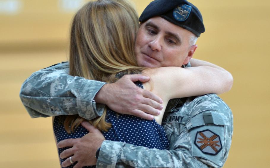 Col. David H. Carstens embraces his wife, Aida, after relinquishing command of the U.S. Army Garrison Wiesbaden to Col. Mary L. Martin Thursday, July 10, 2014 at the Wiesbaden Fitness Center on Clay Kaserne. 

