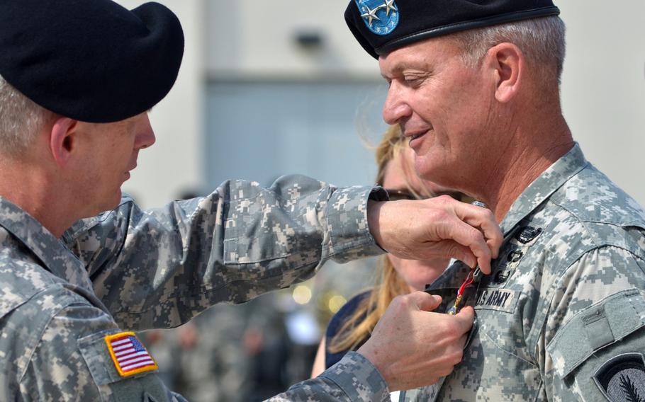 Lt. Gen. Donald M. Campbell Jr., commander of U.S. Army Europe, presents the Distiguished Service Medal to Maj. Gen. Richard Longo (right) at Longo's retirement ceremony on Tuesday, July 22, 2014 at Clay Kaserne in Wiesbaden, Germany. 