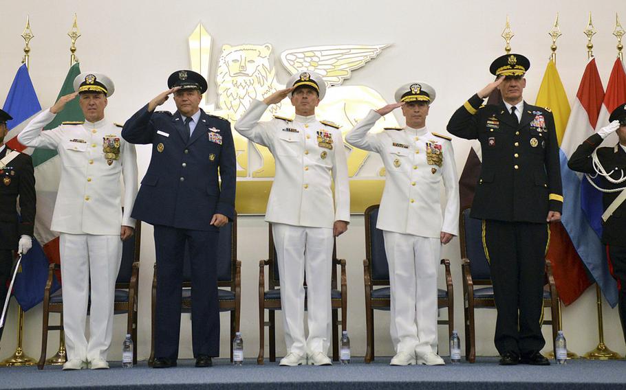 Flag and general officers stand on the theater stage at Allied Joint Forces Command Naples in Lago Patria, Italy, for the ceremony in which Adm. Mark E. Ferguson III, left, relieved Adm. Bruce Clingan, second from right, as commander of U.S. Naval Forces Europe-Africa and Allied Joint Forces Naples. Pictured, from left to right, are Ferguson; Gen. Philip M. Breedlove, Supreme Allied Commander Europe; Jonathan W. Greenert, Chief of Naval Operations; Clingan; and Gen. David M. Rodriguez, commander of U.S. AFRICOM.