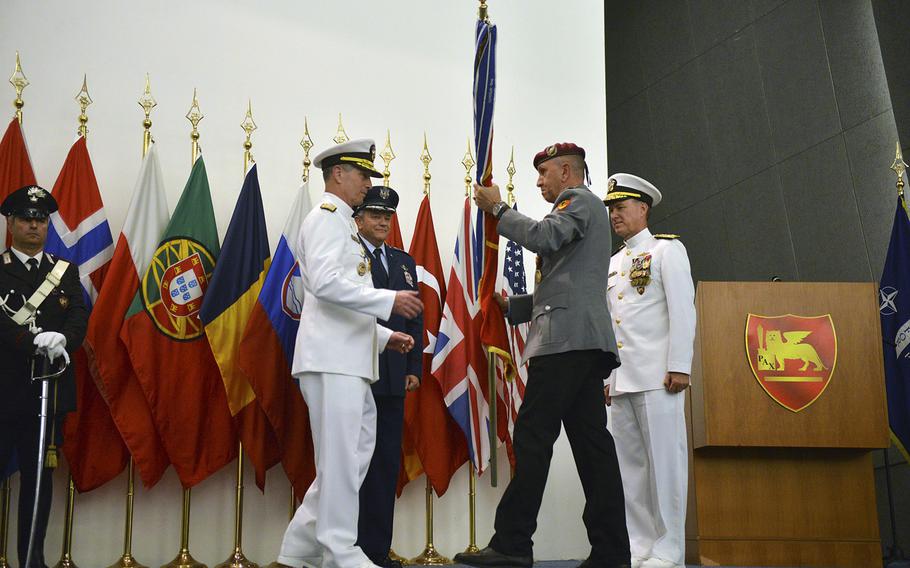 Adm. Mark E. Ferguson III, left, accepts the guidon during a command change ceremony on July 22, 2014, at Allied Joint Forces Command Naples in Lago Patria, Italy. Ferguson relieves Adm. Bruce Clingan, right, as commander of U.S. Naval Forces Europe-Africa and JFC Naples. Also pictured, behind Ferguson, is Gen. Philip M. Breedlove, commander of U.S. European Command and Supreme Allied Commander Europe.