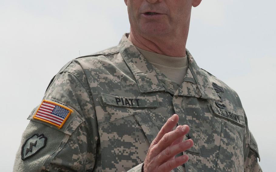 Maj. Gen. Walter Piatt, the outgoing commander for the 7th Army Joint Multinational Training Command, addresses the gathered crowd during his change of command ceremony held at Grafenwoehr, July 21, 2014. 