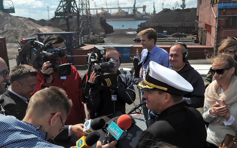 Polish reporters surround Cmdr. Brian Diebold, commanding officer of the USS Oscar Austin in the Baltic port of Gdynia on July 1, 2014. The guided missile destroyer is making the Navy's first visit to the Baltic Coast since Russia's annexation of Crimea. 