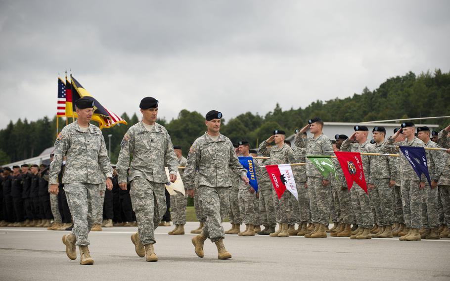 Col. Thomas Mackey, the Joint Multinational Readiness Center commander of operations group; Lt. Col. Patrick Kinsman, the JMRC deputy commander of operations group; and Brig. Gen. Christopher Cavoli, commander of the Joint Multinational Training Command, inspect the troops during an assumption-of- command ceremony held at the Hohenfels training facility, Aug. 14, 2014.

