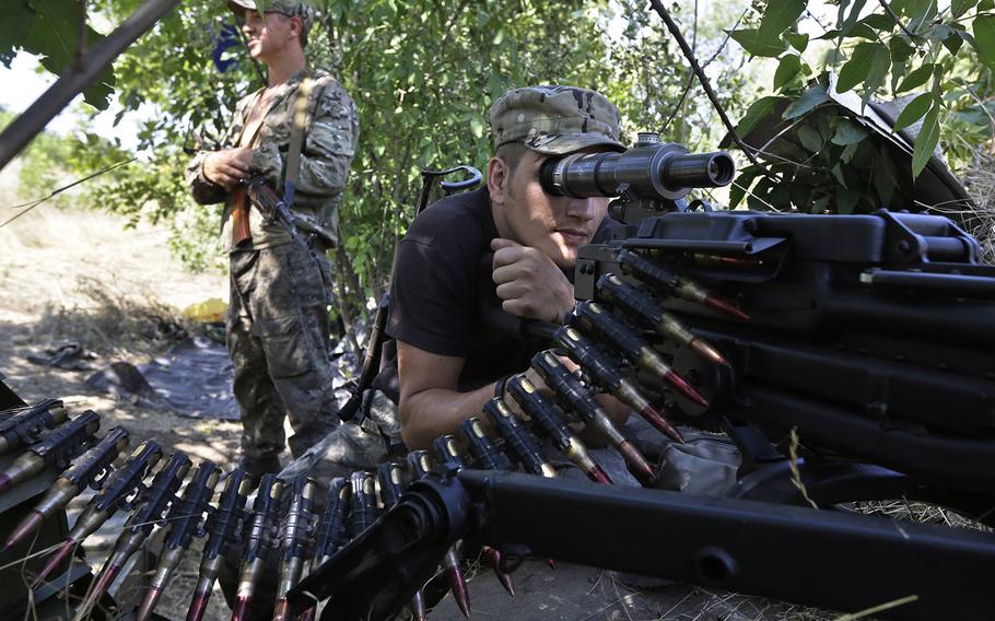 Pro-Russian rebels hold their positions on the frontline near the village of Krasnodon, eastern Ukraine, on Aug. 15, 2014. 
