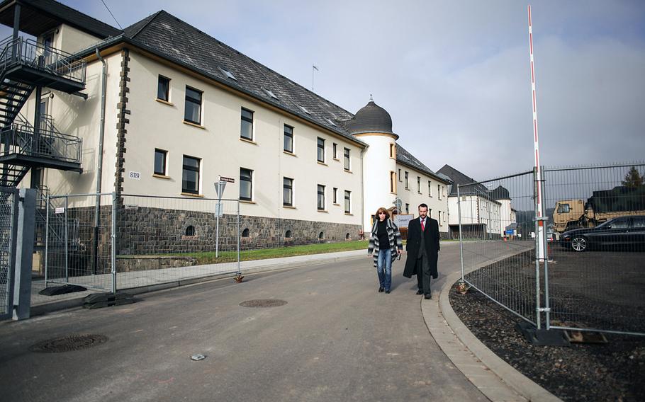 Army public affairs personnel walk out of the gate of the service's controlled monitoring facility in Baumholder, Germany, where troops redeploying from Ebola-stricken parts of Africa were to spend 21 days under observation for signs of the disease.