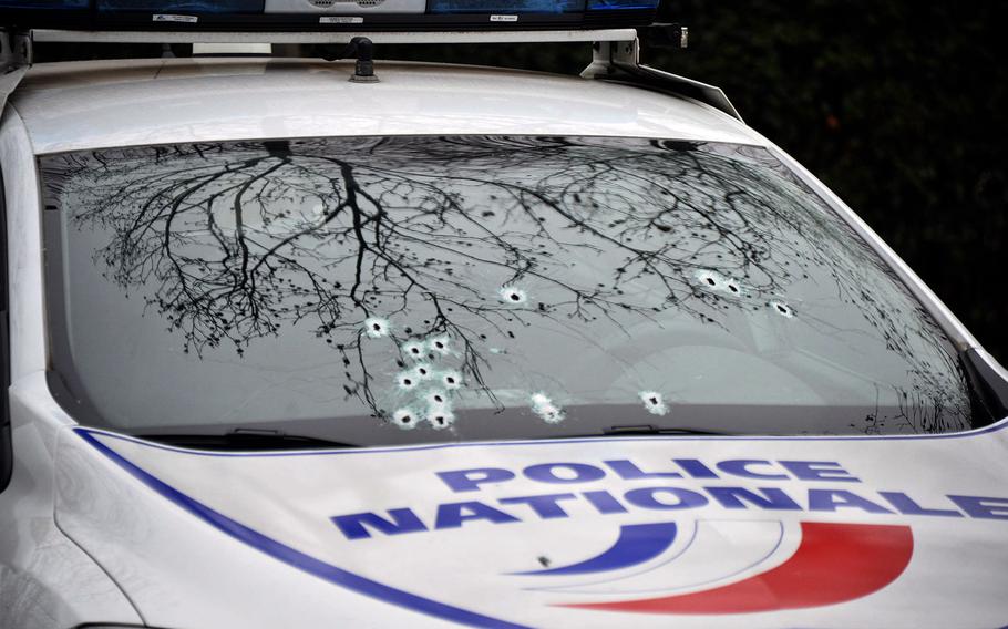 A bullet-ridden police car outside the Paris office of French satirical magazine Charlie Hebdo, Jan. 7, 2015.