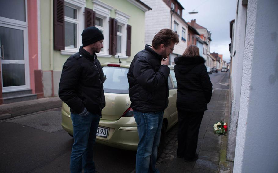 Andrey Chepusov, Dennis Bushmitch and Eugenia Bushmich, the brothers and mother of slain Petty Officer 2nd Class Dmitry Chepusov, stand outside of the apartment building in Kaiserslautern, Germany, on Jan. 30, 2015, where the sailor was killed. His American Forces Network colleague, Air Force Staff Sgt. Sean Oliver, was found guilty of his December 2013 murder and sentenced to life in prison.