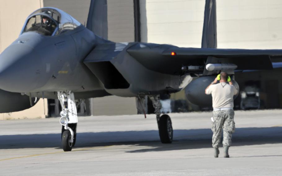 A Florida Air National Guard crew chief prepares to launch an F-15 for a routine training mission at the 125th Fighter Wing, Jacksonville, Fla., in August 2014. About 200 airmen and 12 aircraft from the wing are deploying soon to Europe in support of Operational Atlantic Resolve.