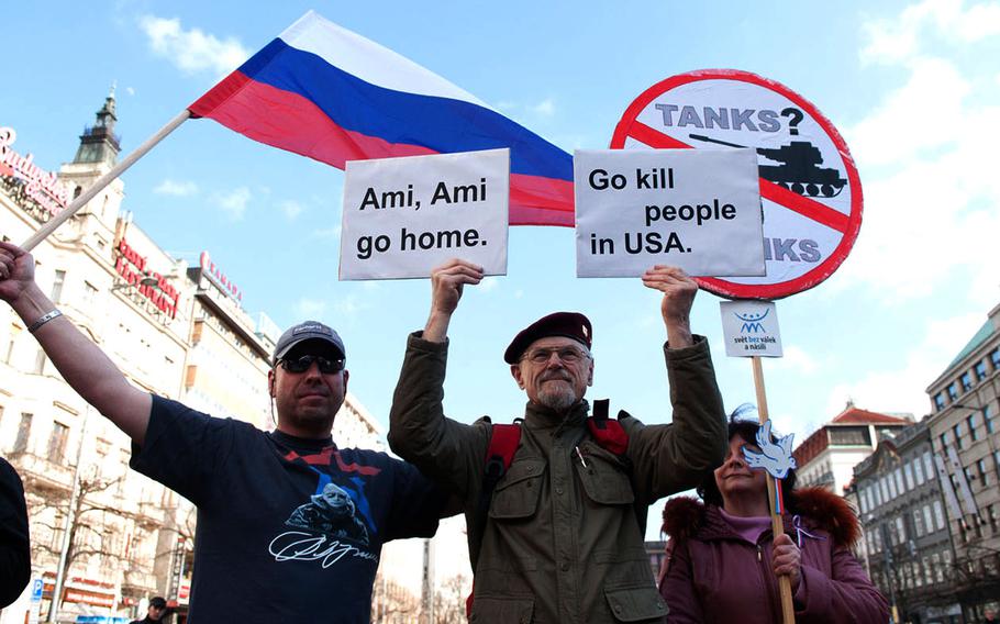 Protesters express their oppositiion to the crossing of a U.S. convoy through the Czech Republic during a demonstration in Prague on Saturday, March 28, 2015.