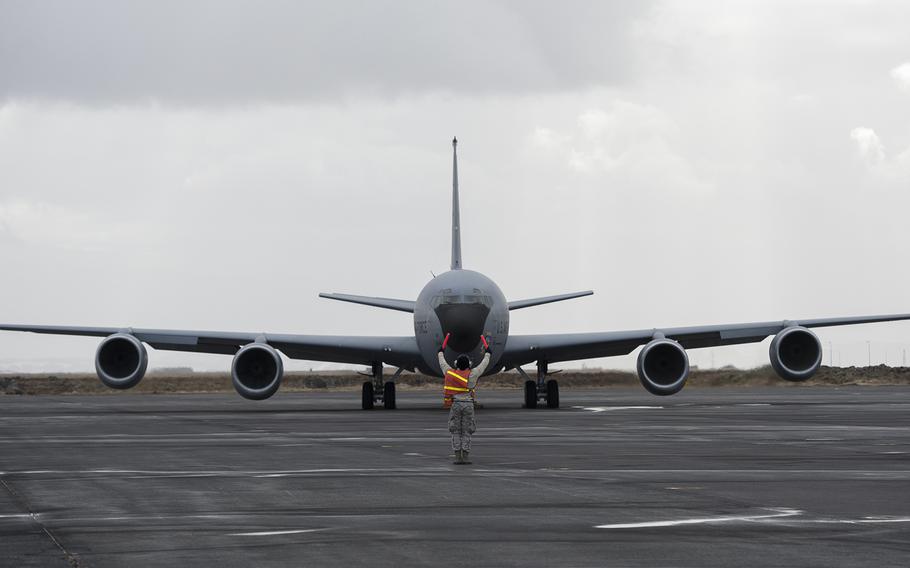 An Air Force aero repair technician taxis a KC-135 Stratotanker aircraft before takeoff during the Icelandic Air Surveillance and Policing mission at the Keflavik International Airport April 21, 2015.