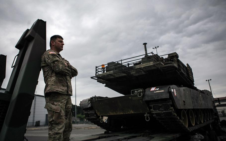 Sgt. 1st Class James Browning of Company C, 3rd Combined Arms Battalion, 69th Armor Regiment, watches an Air Force C-5 transport plane taxi Saturday, June 20, 2015, while waiting to load an M1A2 Abrams tank onto a C-17 transport plane at Ramstein Air Base in Germany.

