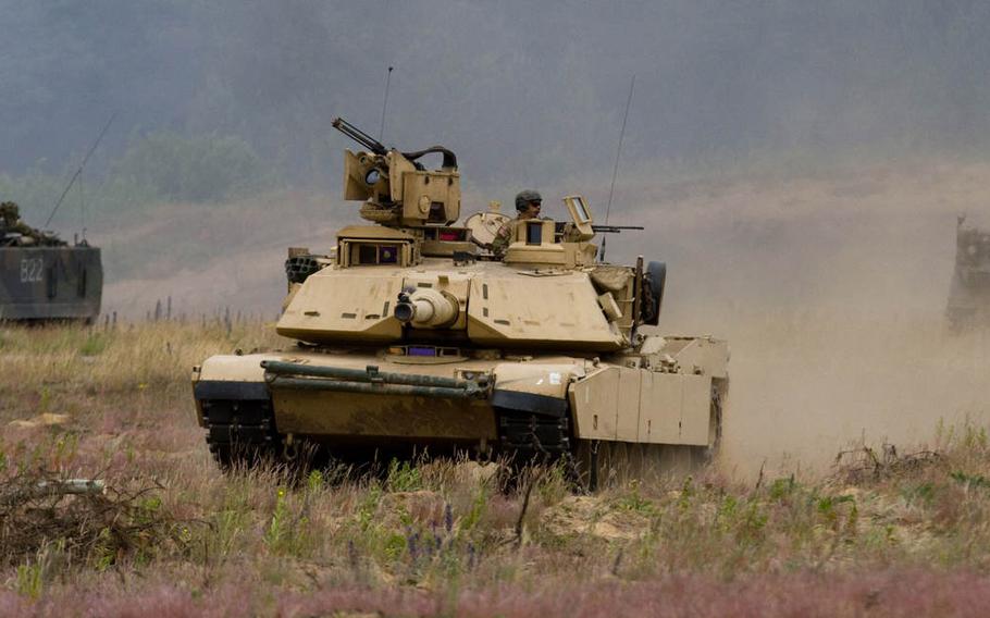 A U.S. Army Abrams M1A2 tank leads the charge during a battle demonstration along with two Lithuanian Land Forces M113 armored personnel carriers  June 18, 2015, during the final day of Saber Strike 2015 at the Great Lithuanian Hetman Jonusas Radvila Training Regiment.