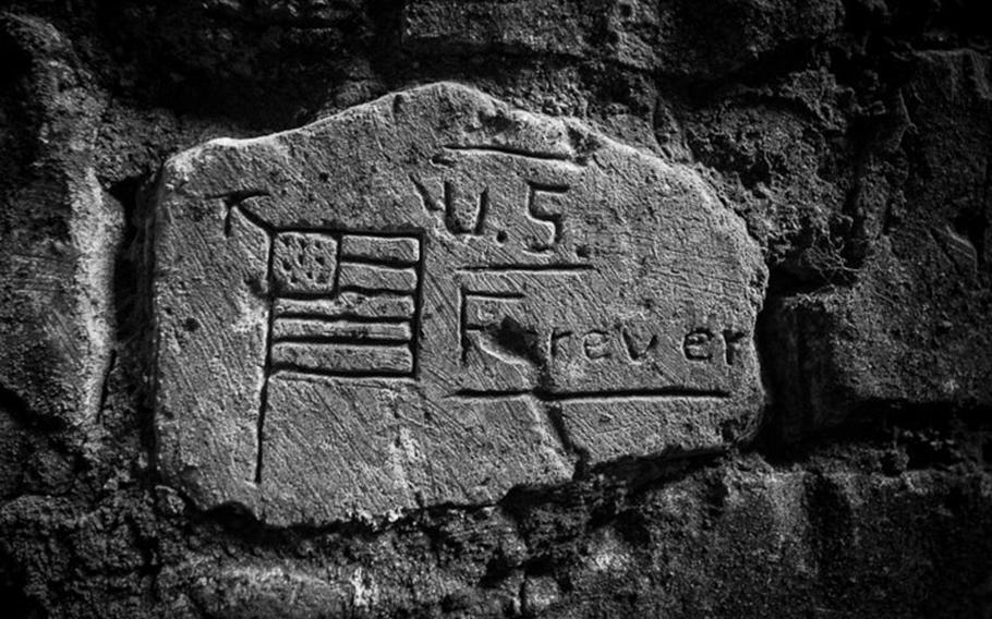 An engraving left behind by U.S. soldiers from the 1st Division in France during WWI reads "U.S. Forever." Photographed in January 2014, in Cantigny, France.