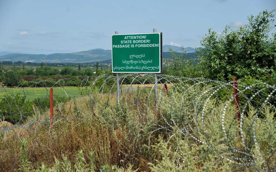 A section of the border between the breakaway enclave of South Ossetia and Georgia near Khurvaleti is well marked by signs and barbed wire. Another section nearby is not and was the scene of a tense standoff between Georgian police and armed, uniformed men who crossed over from South Ossetia, Thursday, July 16, 2015.