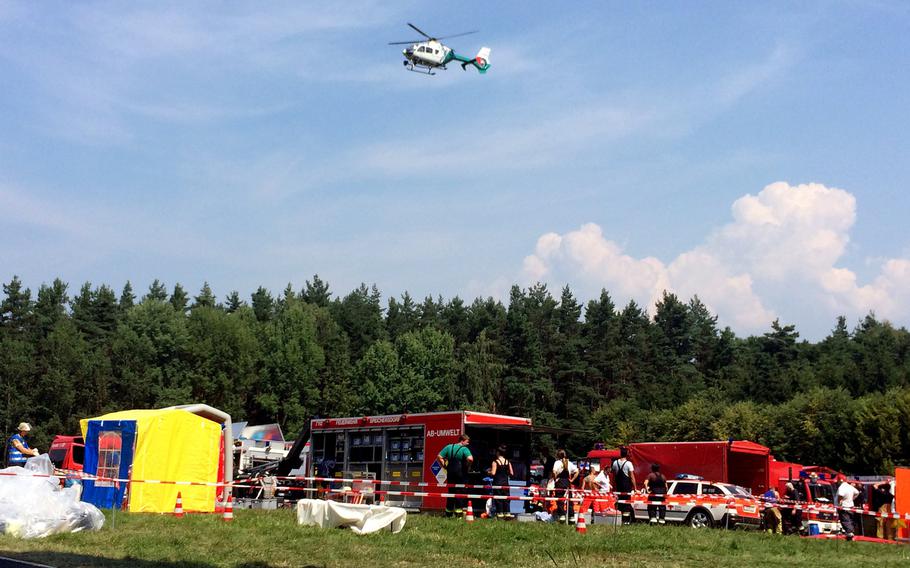 Emergency workers respond to the crash of an F-16 figher jet near the city of Bayreuth, Germany, Tuesday, Aug. 11, 2015. The jet, out of Spangdahlem Air Base, Germany, crashed Tuesday morning. A German police spokesman said the pilot ejected safely.