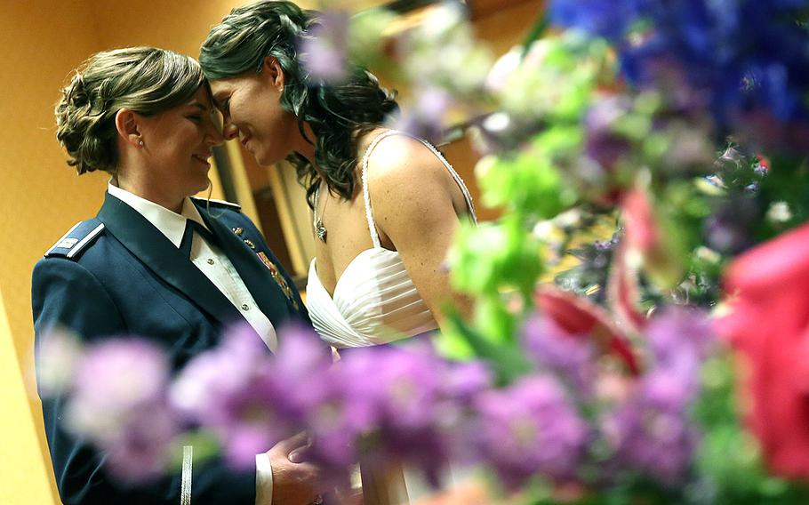 Air Force Capt. Dawn Tanner and retired Lt. Col. Dana McCown stand together before their wedding in Omaha, Neb., on May 3, 2013. Recent legislation has given servicemembers and dependents in same-sex marriages access to the same benefits and assignment opportunities as heterosexual couples.
