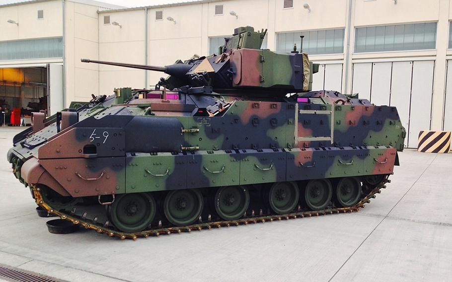 A U.S. Army Bradley Fighting Vehicle painted woodland green sits at Coleman Barracks in Mannheim, Germany, Tuesday, Sept. 1, 2015.
