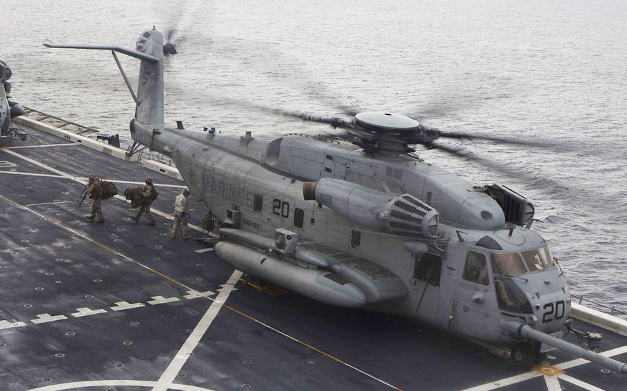 U.S. Marines embarked on the amphibious transport dock ship USS Arlington offload from a CH-53E Super Stallion off the coast of Portugal, Oct. 24, 2015. 