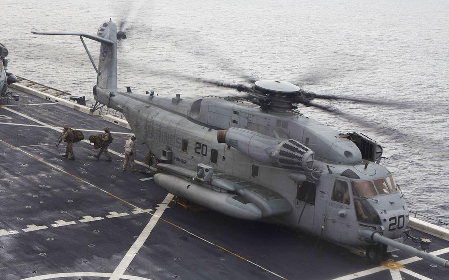 U.S. Marines embarked on the amphibious transport dock ship USS Arlington offload from a CH-53E Super Stallion off the coast of Portugal, Oct. 24, 2015.