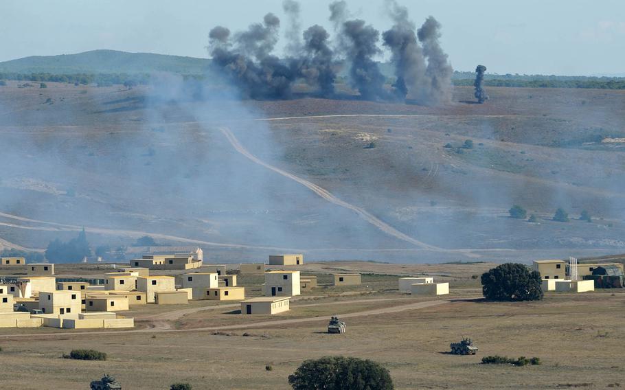 Smoke rises over the San Gregorio training area near Zaragoza, Spain, after an artillery strike during NATO's Trident Juncture exercise, Wednesday, Nov. 4, 2015. The village in the foreground was the objective of the NATO troops participating.

