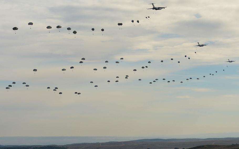 After jumping from C-17 airplanes, paratroops from the U.S. Army's 82nd Airborne and a Spanish unit parachute on to the San Gregorio training area near Zaragoza, Spain, during NATO's Trident Juncture exercise, Wednesday, Nov. 4, 2015.

