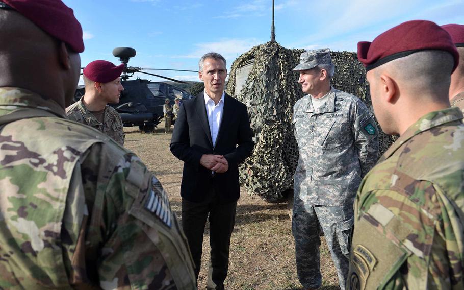 Lt. Gen. John Nicholson listens as NATO General-Secretary Jens Stoltenberg talks with 82nd Airborne soldiers who parachuted onto the San Gregorio training area near Zaragoza, Spain, during NATO's Trident Juncture exercise, Wednesday, Nov. 4, 2015.
 
