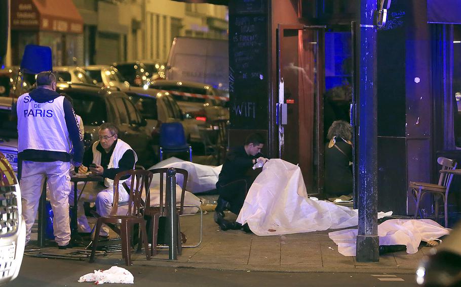 Victims lay on the pavement outside a Paris restaurant, Friday, Nov. 13, 2015.