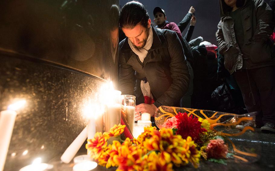 People light candles at a vigil outside the French consulate in Montreal, Friday, Nov. 13, 2015. Canadian Prime Minister Justin Trudeau offered "all of Canada's support" to France on Friday night in the wake of "deeply worrying" terrorist attacks in Paris.