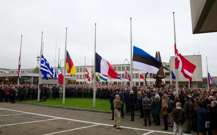 Staff members and others gather for a minute of silence at NATO Headquarters in Brussels on Monday, Nov. 16, 2015, in memory of the victims of the terrorist attacks in Paris.