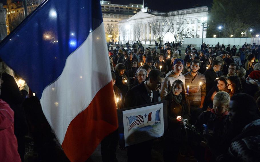 A crowd gathers for a vigil in honor of the victims of terrorist attacks in Paris at Lafayette Square, outside the White House, on Saturday, Nov. 14, 2015, in Washington, D.C. People gathered in cities around the world to show support for Paris following the coordinated assault that left at least 129 people killed and more than 350 injured. 