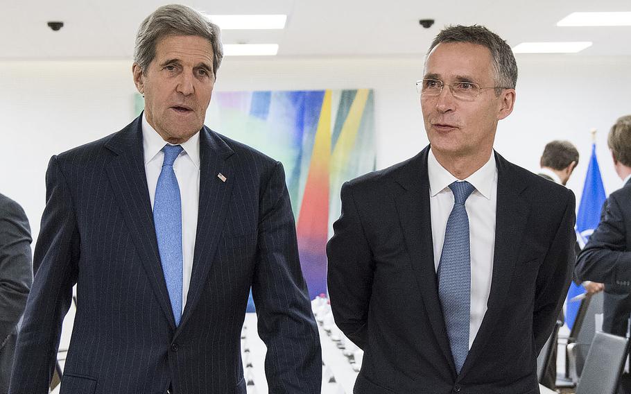 U.S. Secretary of State John Kerry, left, and NATO Secretary General Jens Stoltenberg walk towards a meeting room on Tuesday, Dec. 1, 2015. 
