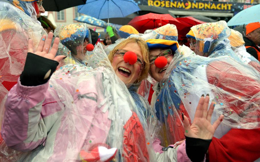 Despite a steady drizzle and cold wind, participants had a good time celebrating Altweiberfastnacht, or old women's carnival, on Schillerplatz in downtown Mainz, Germany, Thursday, Feb. 4, 2016. The event traditionally kicks off the final six days of the German carnival season, culminating in the giant Rose Monday parades in Mainz, Cologne and Duesseldorf.

